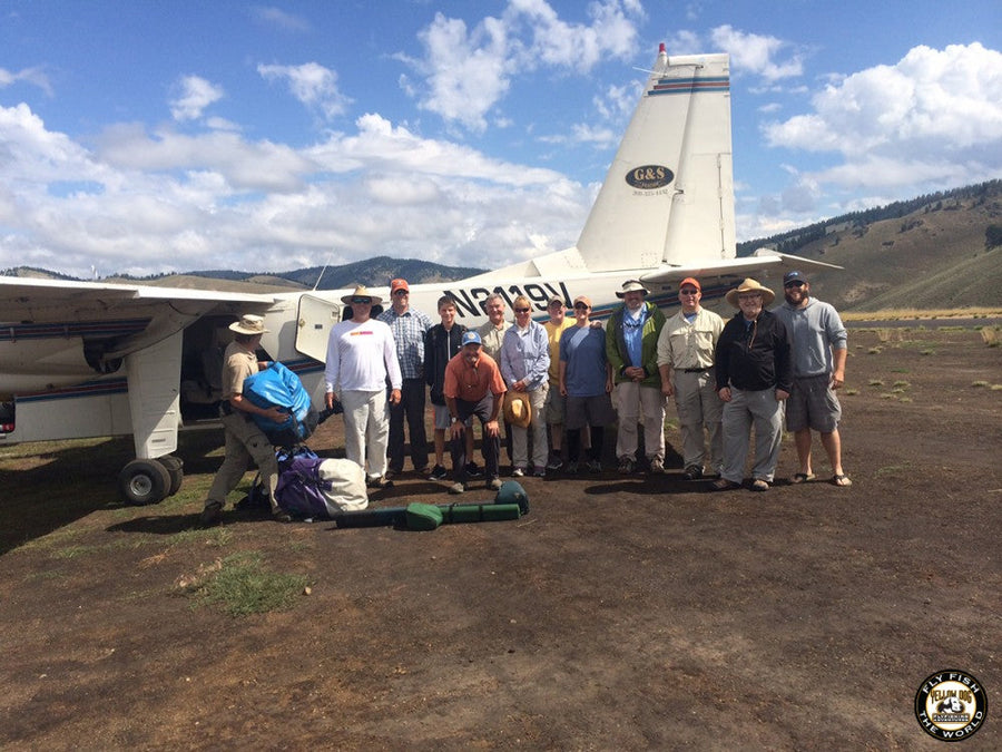 Yellow Dog Flyfishing team and guests beside a bush plane on an Idaho dirt airstrip before a backcountry fly fishing trip