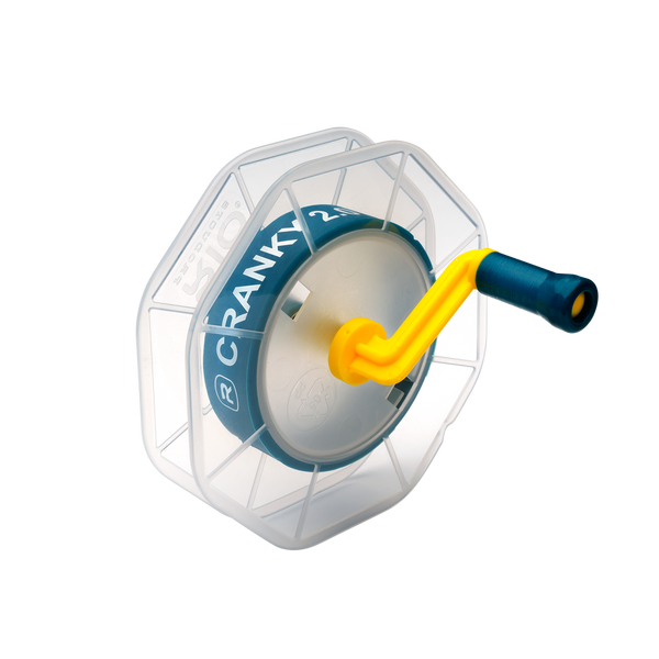 Angled view of RIO Cranky Kit 2.0 showcasing blue spool labeled CRANKY 2.0, yellow crank handle, and silicone shim on white background