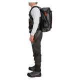 Side view of Simms G3 Guide Backpack in Anvil showing waterproof roll-top closure and padded harness on white background
