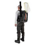 Rear view of Simms G3 Guide Backpack showcasing roll-top waterproof design, rod-tube pocket and net attachment on white