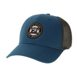 Angled view of Lo-Pro trucker hat in marine blue with curved brim, gray mesh back and Yellow Dog fly fishing patch