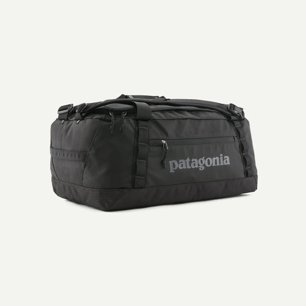Three-quarter view of Patagonia Black Hole Duffel 40L showing side pocket, padded straps and logo on light background
