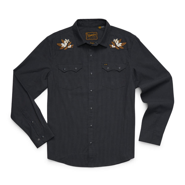 Flat lay of Crosscut Deluxe snap shirt, antique black, embroidered shoulder blossoms and front snap pockets on white