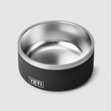 Angled front view of YETI Boomer 8 dog bowl showing stainless steel interior and black exterior with YETI logo
