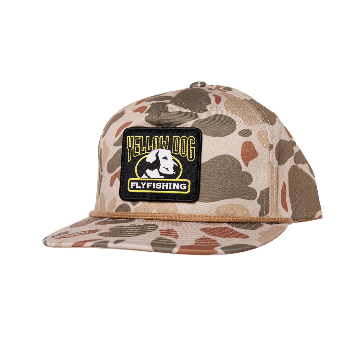 A flat-brim snapback cap in a desert camouflage pattern, featuring a black rectangular patch on the front with the text 'YELLOW DOG FLYFISHING' and a dog graphic.