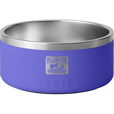 Angled front of YETI Boomer 8 dog bowl showing stainless-steel interior and Ultramarine Violet exterior with embossed YETI