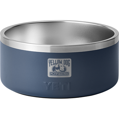 Front view of navy YETI Boomer 8 dog bowl showing stainless steel interior and Yellow Dog Flyfishing logo on white background