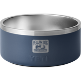 Front view of navy YETI Boomer 8 dog bowl showing stainless steel interior and Yellow Dog Flyfishing logo on white background